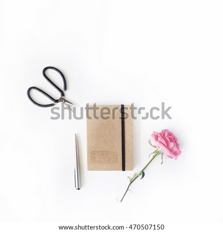 pink rose, scissors, craft diary and pen on white background. flat lay, top view