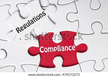 Compliance and Regulation words written on white puzzle piece,business concept background
