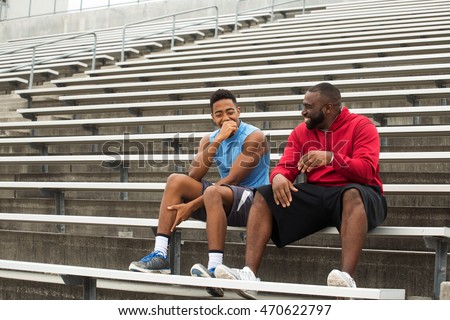 Coach spending time mentoring a student athlete. Royalty-Free Stock Photo #470622797