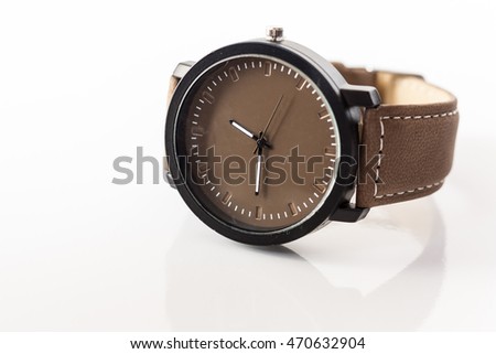 Tan brown wristwatch on plain background