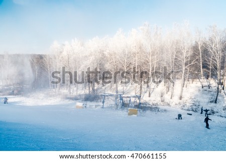 Panorama of the ski resort. Winter landscape. Snowboarders downhill. 
