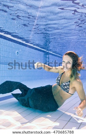 Mermaid on the bottom of swimming pool