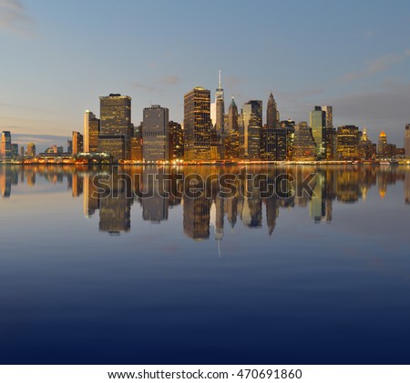 Manhattan skyline reflected in the waters of the East River.
