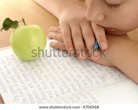 resting schoolgirl with notebook and apple
