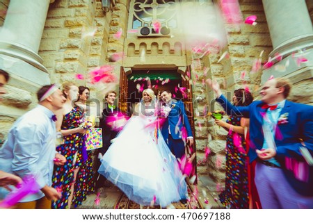 Blurred picture of rose petals falling over attractive wedding couple