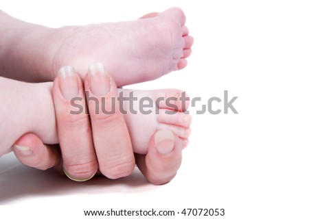 A woman is holding the feet of her child
