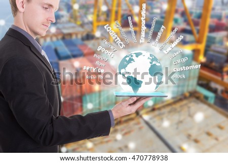 Businessman with tablet on hand show supply chain concept logistics import export over the world,container ship background. (Elements of this image furnished by NASA)