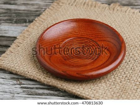 Brown wooden plate on a rustic wooden background,Still life concept.