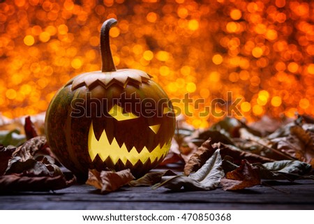 Pumpkin for Halloween, lamp pumpkin, antique wood, celebrating halloween, smiley on a pumpkin, autumn dry leaves, bright background, angry face