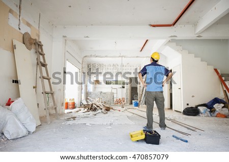 House improvement concept. Rear view of Asian construction worker looking away. Royalty-Free Stock Photo #470857079