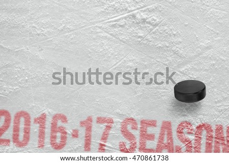Season 2016-2017 year and hockey puck on ice. Concept