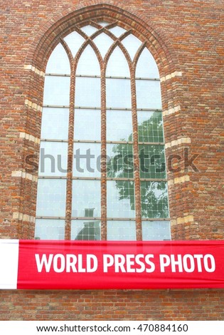 Sign of the World Press Photo exposition at the facade of the Grote Kerk (Big Church) in fortress city of Naarden, Netherlands. This exposition is each year in Naarden.