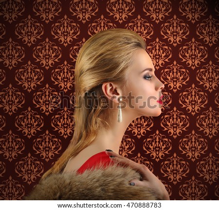 Elegant woman in fur cape on vintage pattern background. Luxury lifestyle.