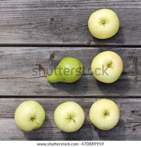 flat lay of apples and pears on old wooden background / real and useful fruit