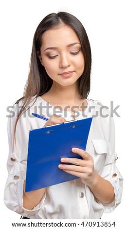 Beautiful business woman taking notes on her clipboard