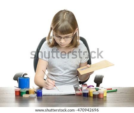 portrait of a girl a child draws with paints isolated on white background