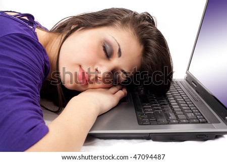 Portrait of a tired brunette sleeping on her laptop