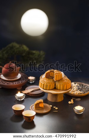 Mid autumn festival mooncake and tea appreciation table top shot with full moon sky background. Shallow depth of field, Royalty-Free Stock Photo #470991992