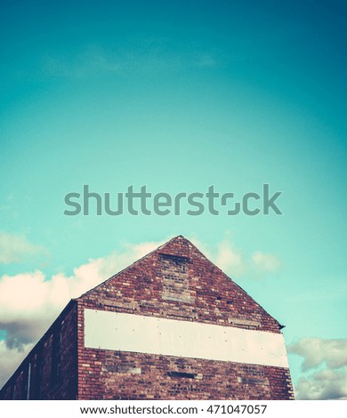 Blank Sign For Your Text On A Red Brick Industrial Building With Blue Sky And Copy Space