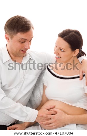 young man with his pregnant wife were sitting on a white