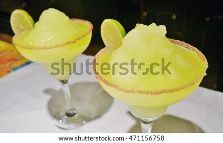 frozen margarita tequila Mexican Mexico lime cocktail in ready for Fiesta party with rimmed glasses stock photo, stock, photograph, image, picture 