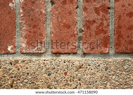 Red bricks next to a pebble walkway.