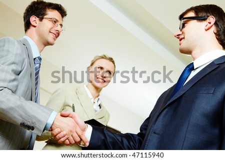 Portrait of business people shaking hands making an agreement