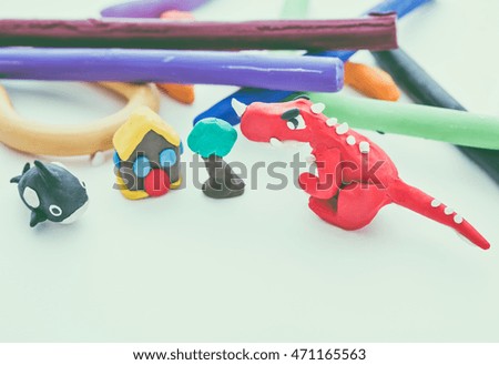 Beautiful play dough animal. Creative clay animal model. Red dinosaur, whale, house and tree from children bright play dough. Studio shot. Vintage tone effect.