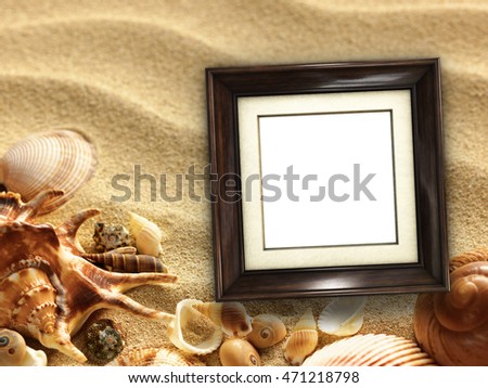 Pictue frame on shells and sand background. Copy space.