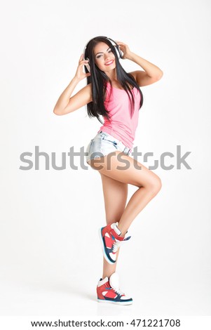 beautiful young woman in headphones listening to music. the girl enjoys the music