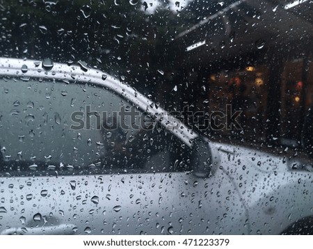 raindrops on a side window of car viewed from the inside.