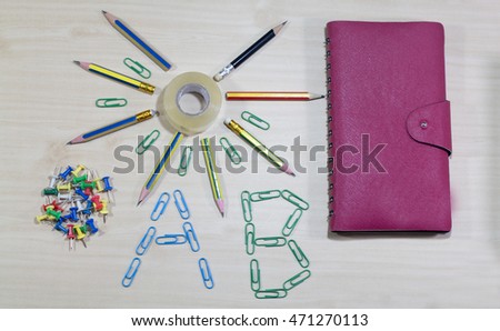 group of pencil,note ,tape on wooden desk