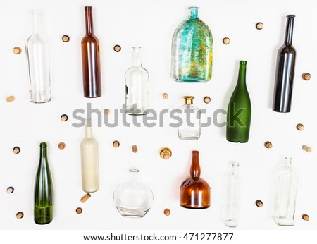 many empty glass bottles and corks on white background