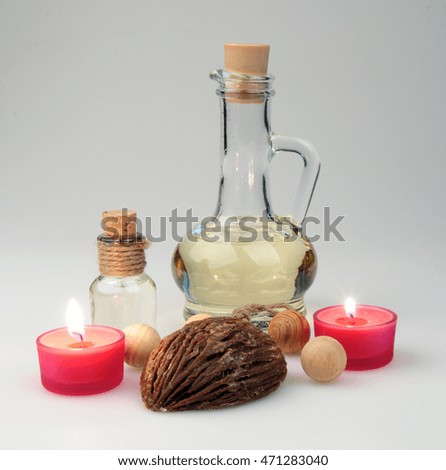 spa composition. scented candles and soap, coffee beans, aromatic wooden balls and oil in a glass jug with a stopper.  partially tinted photo.
