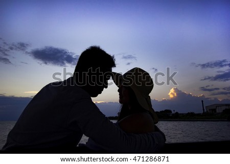 Silhouette picture of the couple at the beach during twilight time