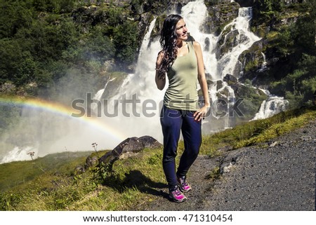 Young woman after going through the waterfall, Briksdal, Norway