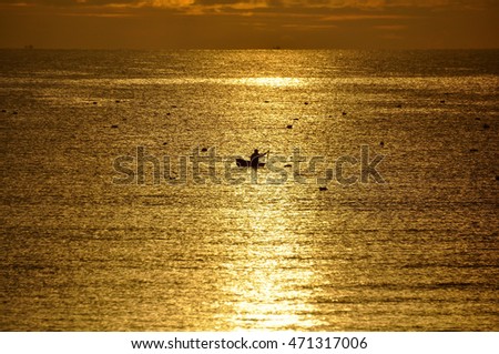 A fisherman in the sea at dawn in Vietnam