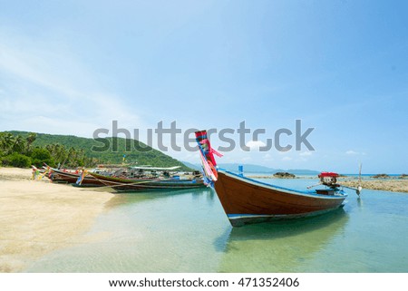JOURNEY CONCEPT, LONG-TAIL BOATS ON CLEAR LOW TIDE SEA WATER AT SEASIDE IN SUNNY DAY, BLUE SKY BACKGROUND