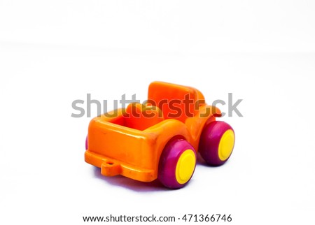 Orange toy car on a white background.