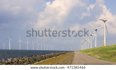Windmill park Westermeerwind the largest wind farm in the Netherlands. 
The wind farm produce 1.4 TWh of electricity annually, enough to provide electricity to over 400,000 households.Urk,Netherlands Royalty-Free Stock Photo #471385466