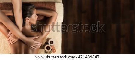 The beautiful girl has relaxing massage. Spa treatment. Design template with the space for placing text Royalty-Free Stock Photo #471439847