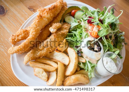 Gourmet fish and chips with salad, stock photo