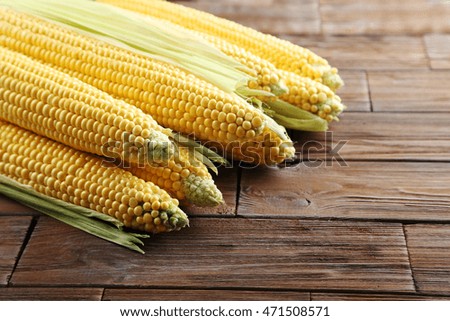 Sweet corns on a brown wooden table