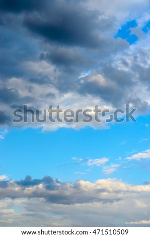 Blue sky through the dark clouds before the rain.