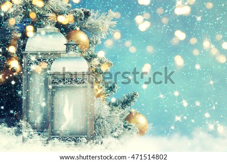 Christmas lantern with Christmas decoration on the snow
