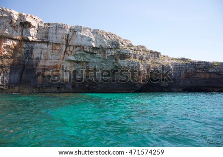 Rock caves and cristal water coastline landscape in Salento, Apulia, Italy