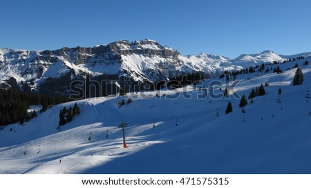 Ski slopes, cable car and mountains. Winter scene in Flumserberg, Switzerland.