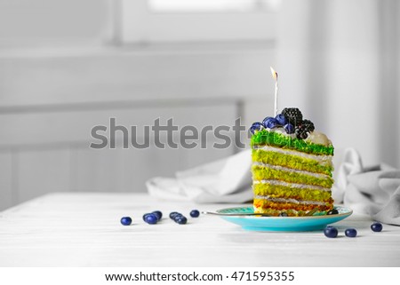 Delicious cake slice with candle on light background