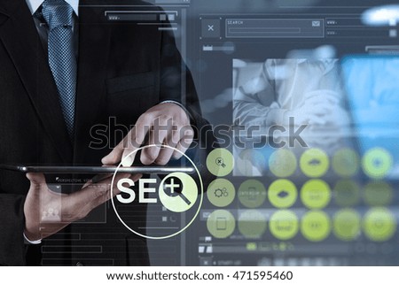 Double exposure of businessman hand showing search engine optimization SEO as concept
