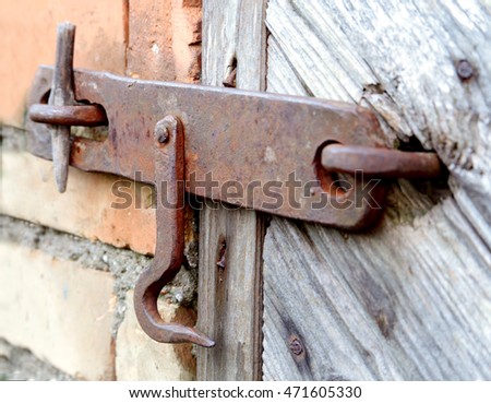 lock on the door of an old farmhouse . true village style .